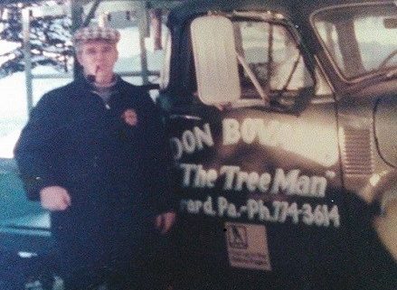 Amys father Don standing by his truck which reads Don Bovaird Tree Man
