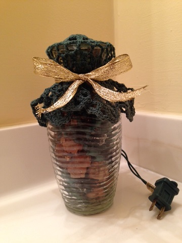 lighted jar filled with Potpourri and tied with bow