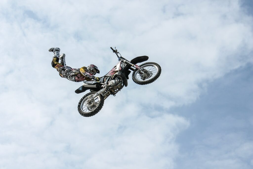 person holding onto motorcycle that is in mid air
Photo by Web Donut on Unsplash