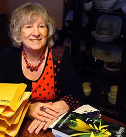 Lynda sitting at desk with her books