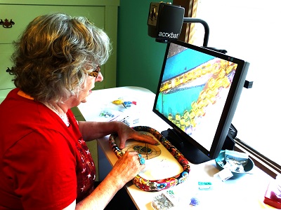 Lynda working in her studio using video magnifier
