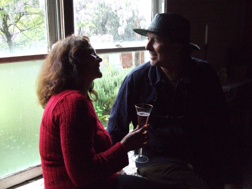 Maribel holding champagne glass and toasting friend.