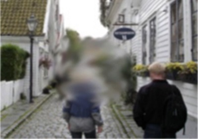 central vision loss from macular degeneration. person walking down street. central part of street is obscured and blurry