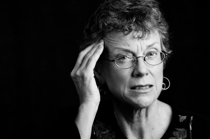 older woman wearing glasses looking upset