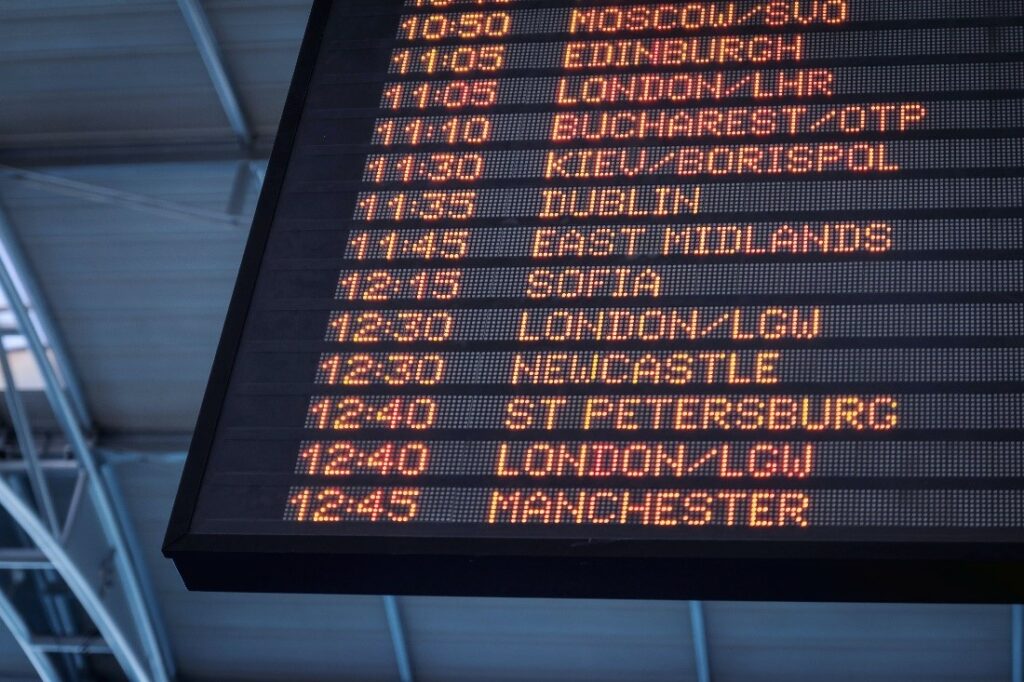 airport flight schedule showing flight times and listing of international cities