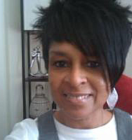 Headshot of Stephanie McCoy smiling and wearing long white earrings