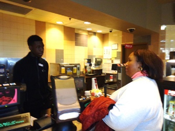 Empish standing in front of popcorn counter at the movies