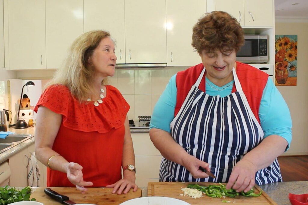 Maribel and Penny Cooking in Kitchen