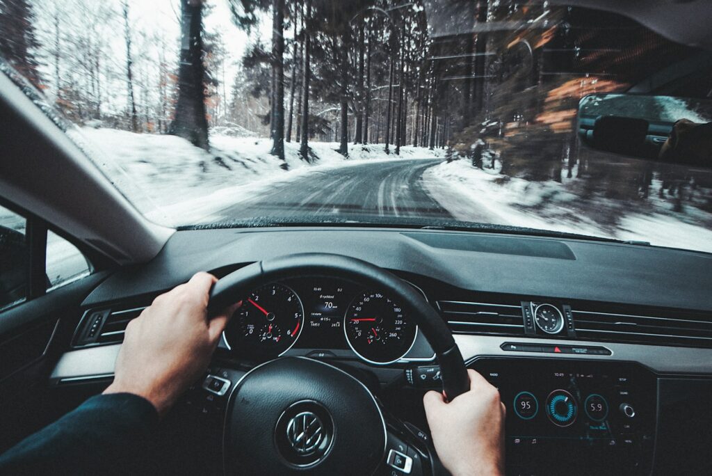 person driving with hands on wheel