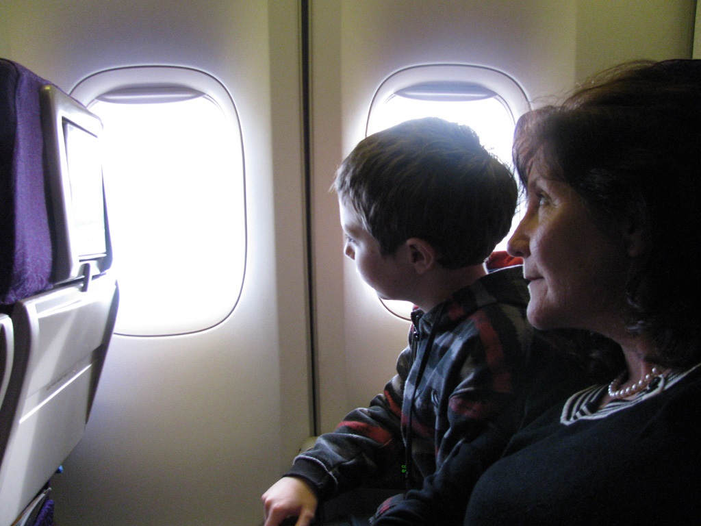 Maribel Sitting by Child Looking out Bus Window