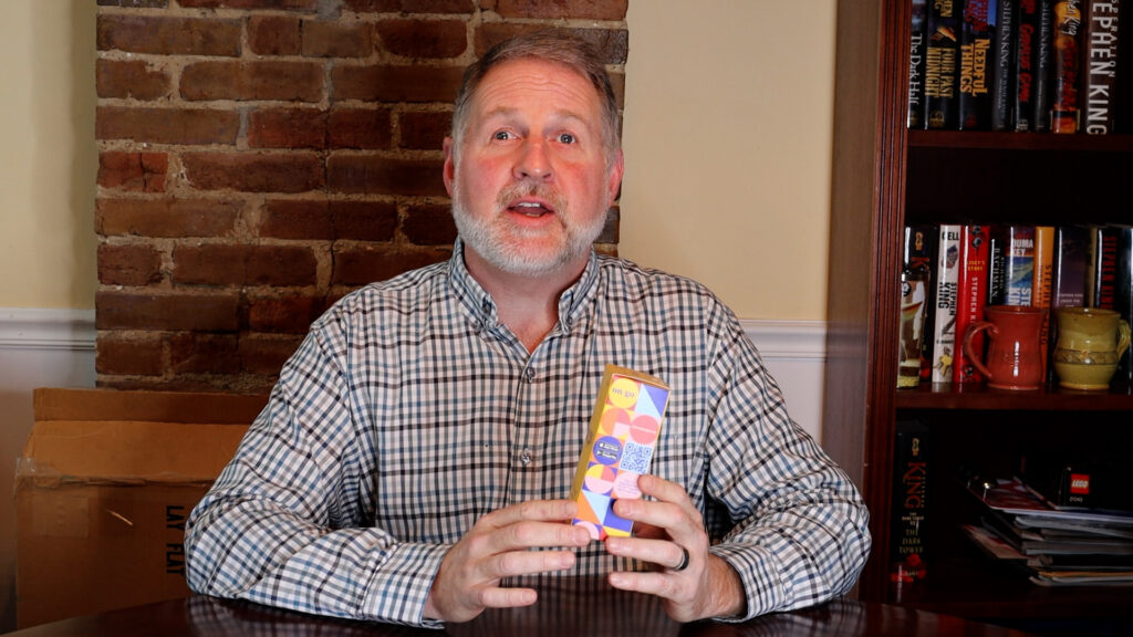 Alan Lovell holding accessible COVID-19 test kit