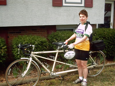 older woman holding tandem bike