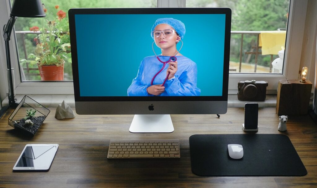 young doctor with stethescope seen on computer screen